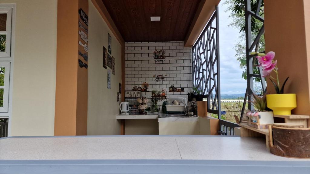 a kitchen with a counter and a window at Pool of Siloam with tiny house in Bangad