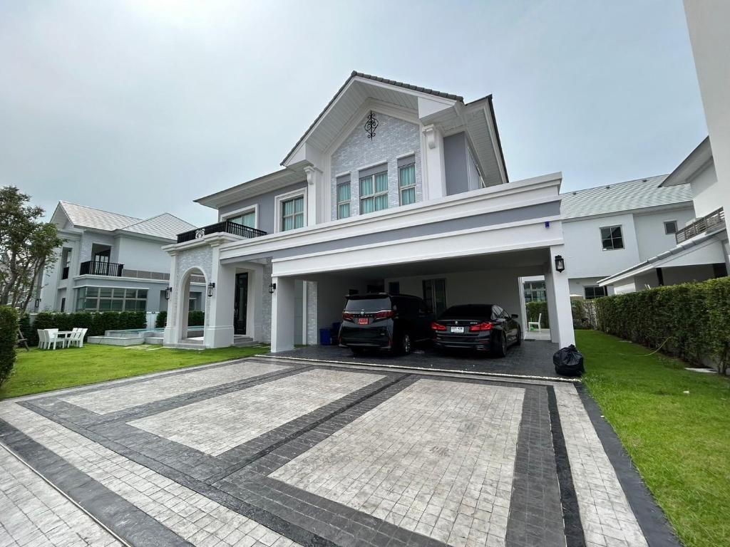 a large white house with a car garage at Luxury house for rent near Suvarnabhumi Airport in Sathani Lat Krabang