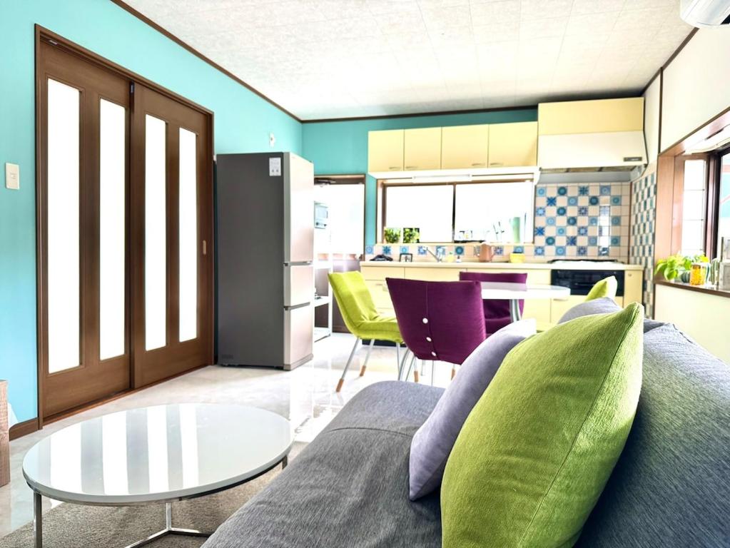 a living room with a couch and a table at 海輪邸 in Shima