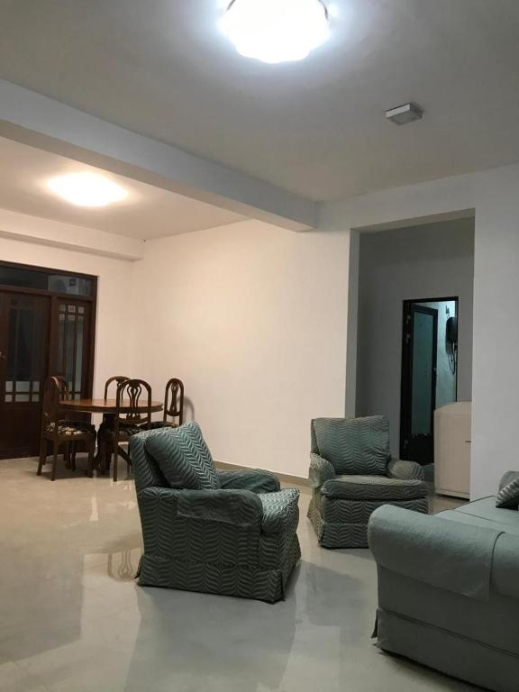 a living room with two couches and a table at Slayan properties in Mudungoda