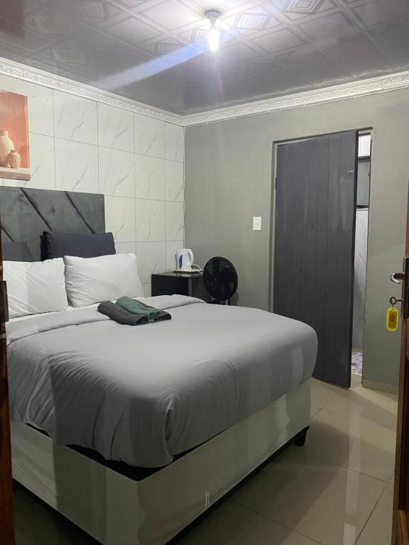a bedroom with a large bed in a room at Namhla Guest House in Nongoma