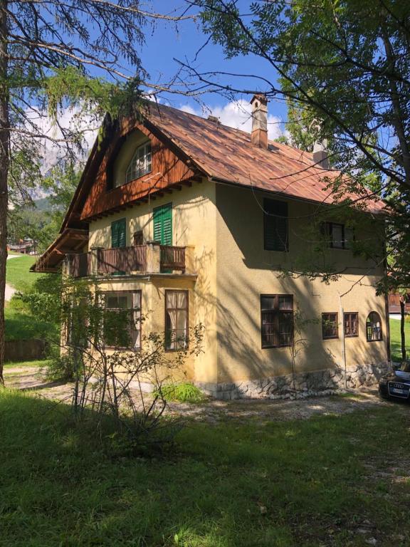 an old house with a red roof at Ca' Il Guscio in Cortina dʼAmpezzo