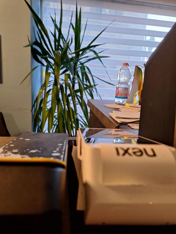 a desk with a laptop and a box on it at Pretoria Collection in Potenza
