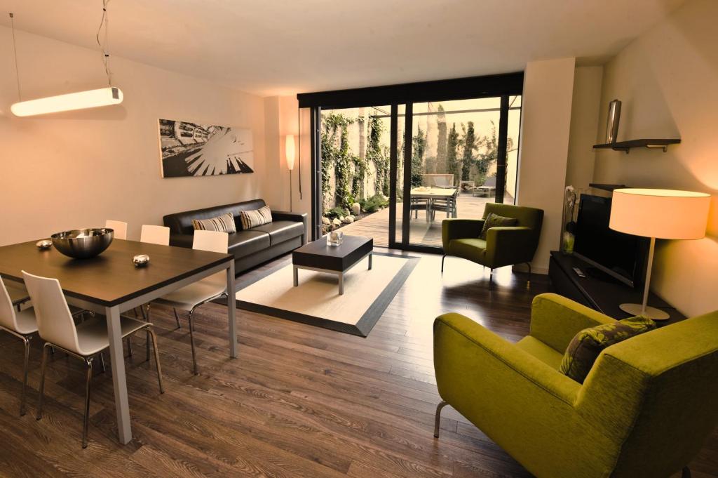 a living room with a couch and a table at Casp 74 Apartments in Barcelona