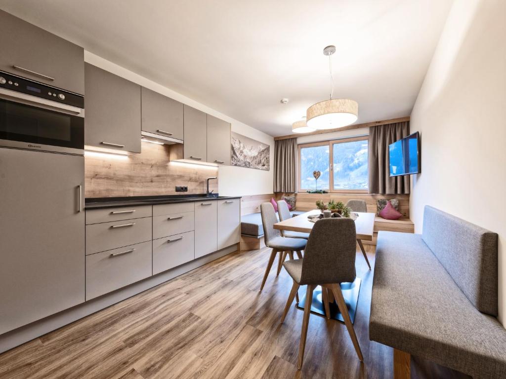 a kitchen and dining room with a table and chairs at Farmhouse in Schwendau with Ski Storage in Hippach