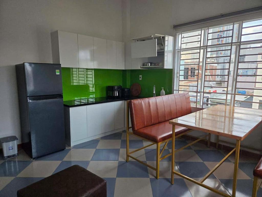 a kitchen with a table and a refrigerator at TH Homestay in Danang