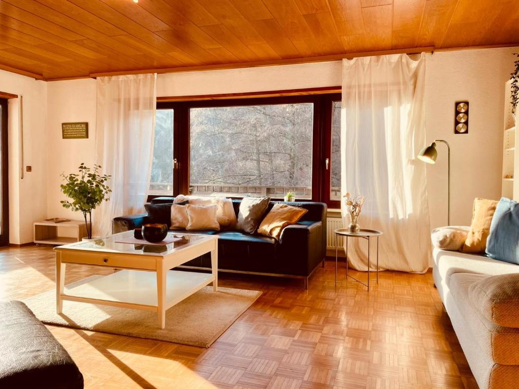 a living room with a couch and a table at Odw homes - Wohnung im Landhaus mit Garten in Trösel