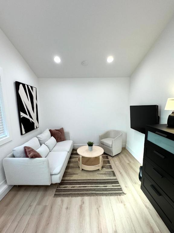 a living room with a white couch and a coffee table at Modern and Cozy Private Studio in Lynnwood