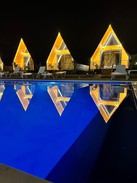 a house with a swimming pool at night at Evergreen Lodge in Çakırlar