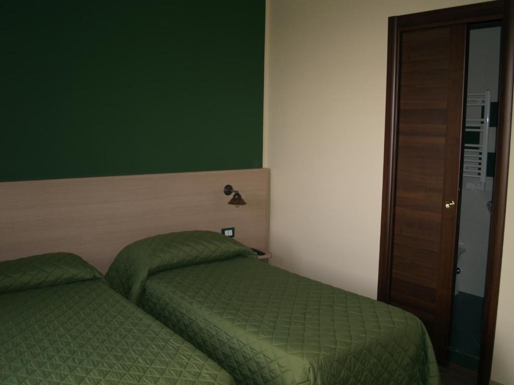 Postel nebo postele na pokoji v ubytování B&B Mamma Elena