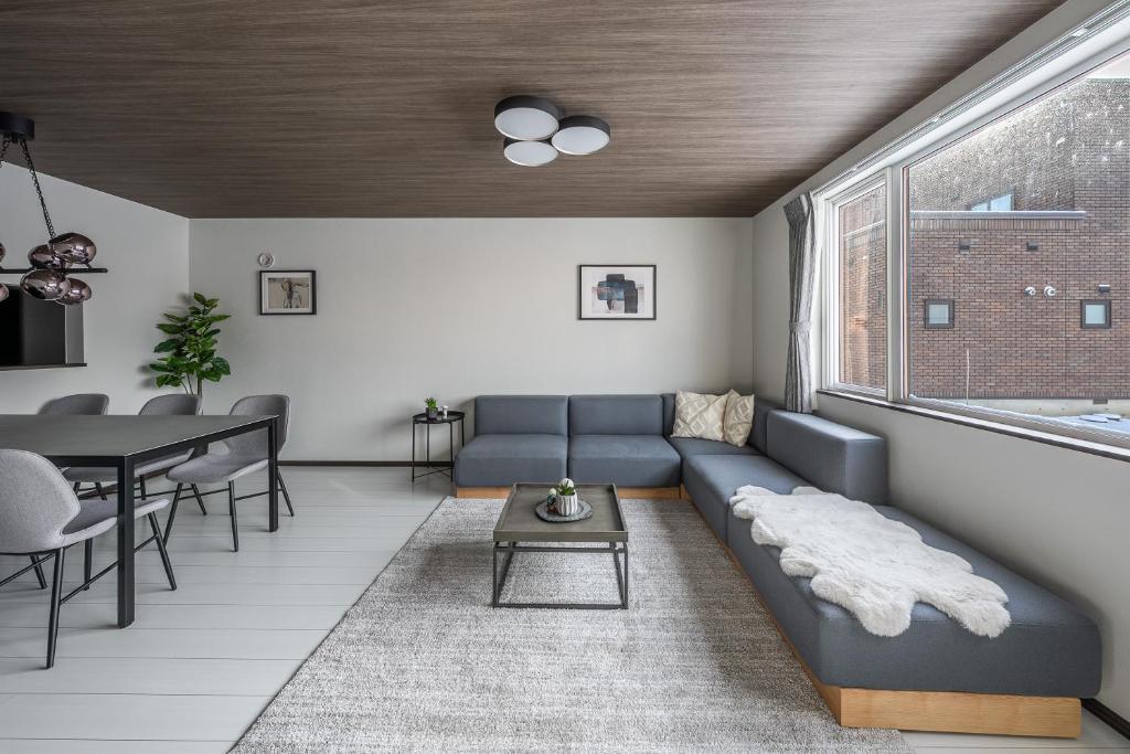 a living room with a couch and a table at Hills Niseko A in Niseko