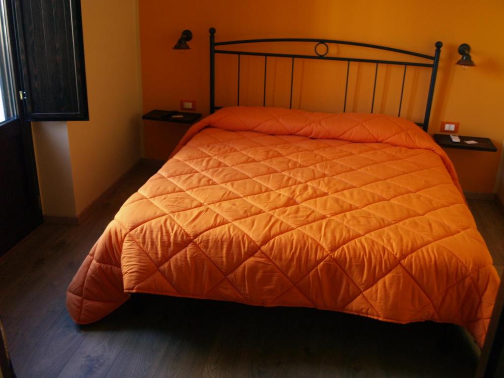 Postel nebo postele na pokoji v ubytování B&B Mamma Elena