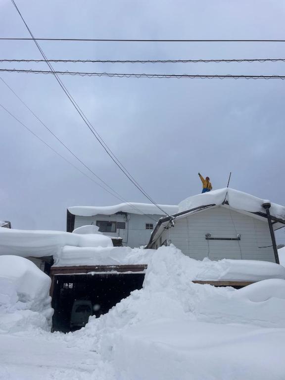 a pile of snow on top of a house at PEUF Lodge in Otari