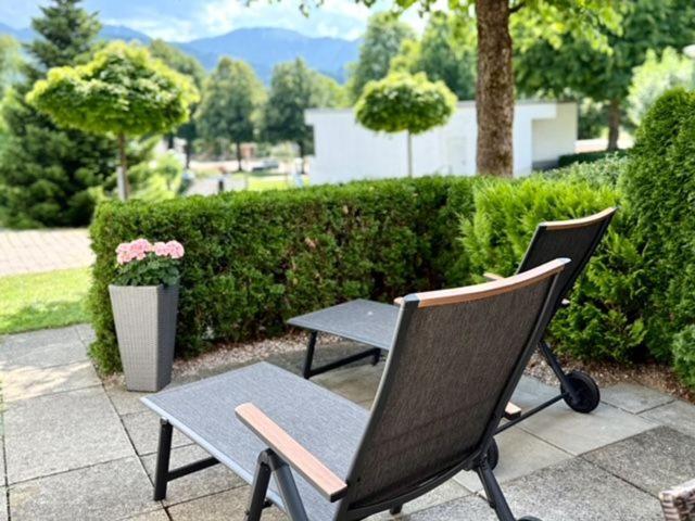 two chairs and a table on a patio at Schliersee-Lounge in Schliersee