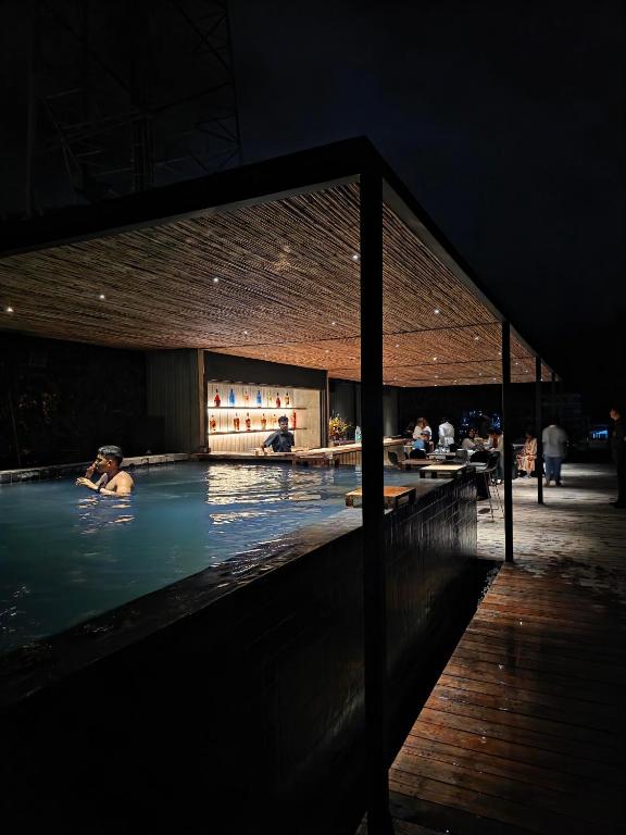 a group of people in a swimming pool at night at Elevate Ella Resort & Spa in Ella