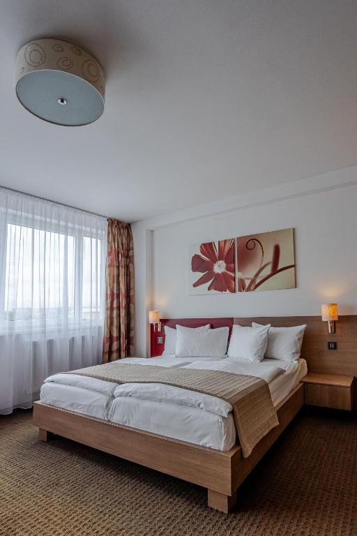 En eller flere senge i et værelse på Hotel Alibaba