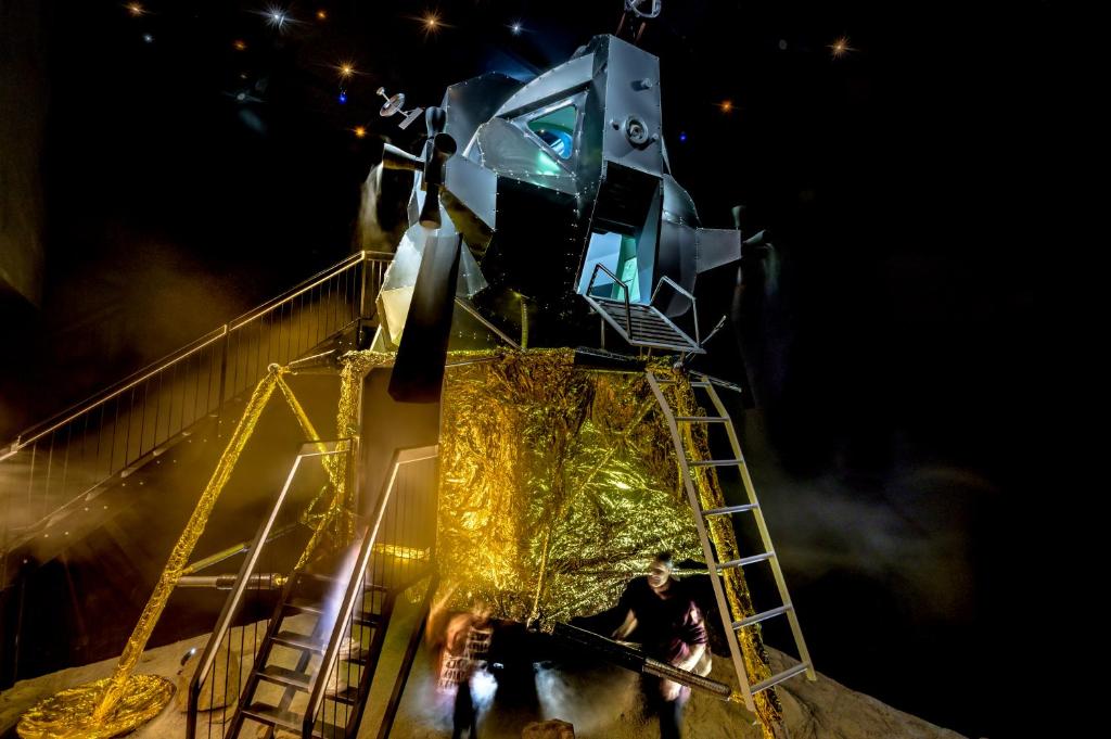 a man is standing on a roller coaster at night at Apollo11 in Collepietra