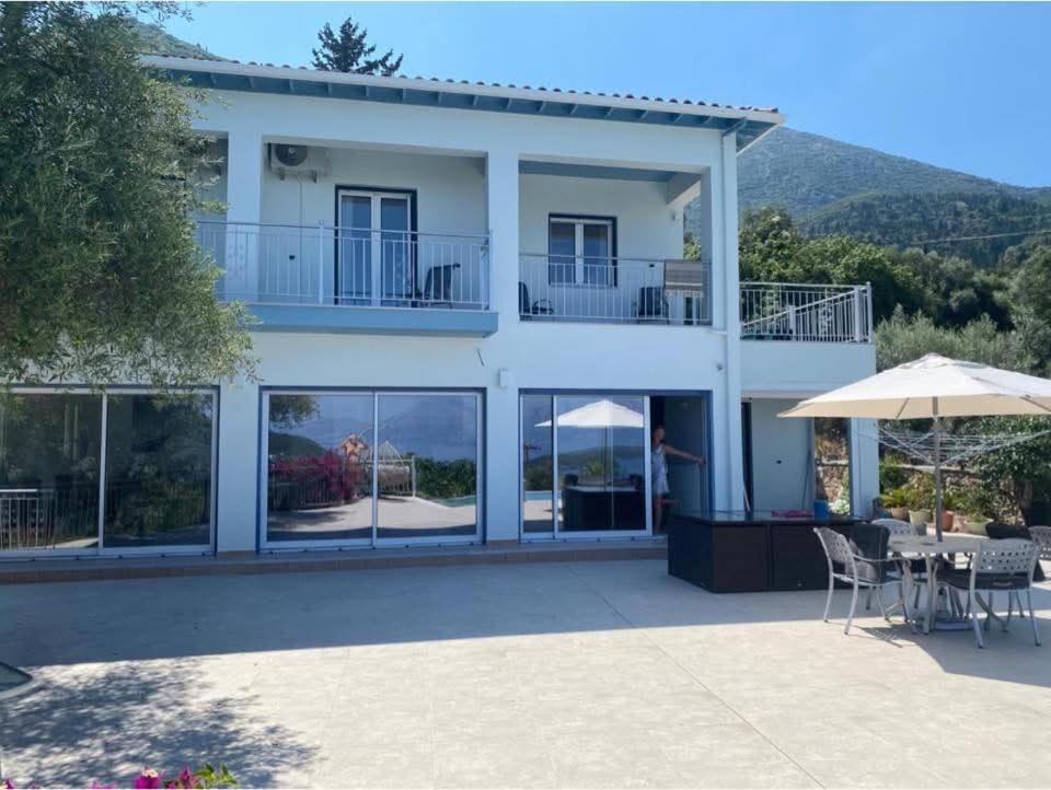 a villa with a view of the house at Villa Christina Nidri in Nydri