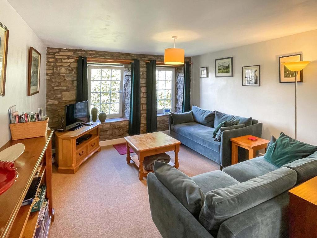 a living room with two couches and a tv at Cauldron Falls in West Burton