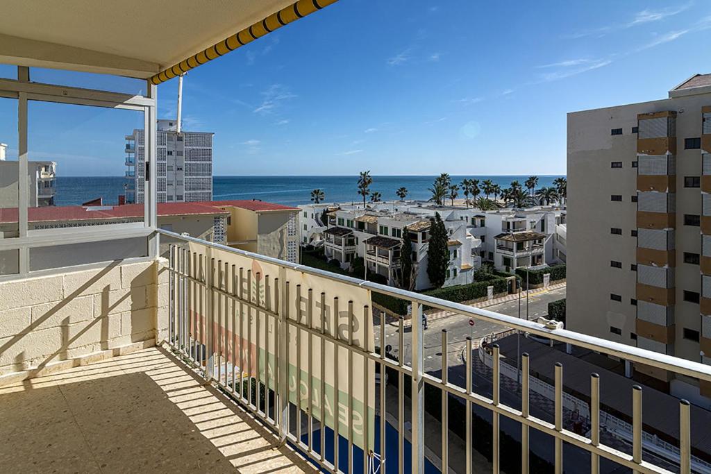 a balcony with a view of the beach and buildings at Maryvent Solo Familias Serviplaya in Playa de Xeraco