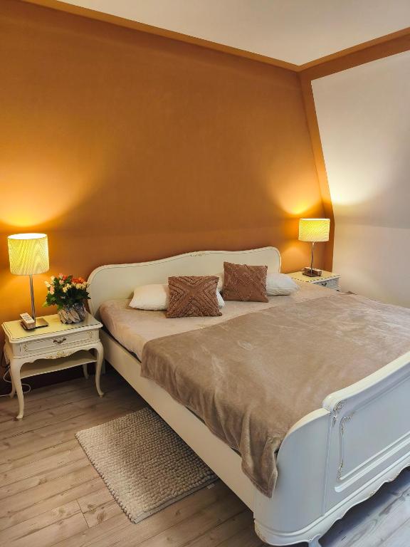 a bedroom with a large bed and two night stands at Watt in Karolinenkoog