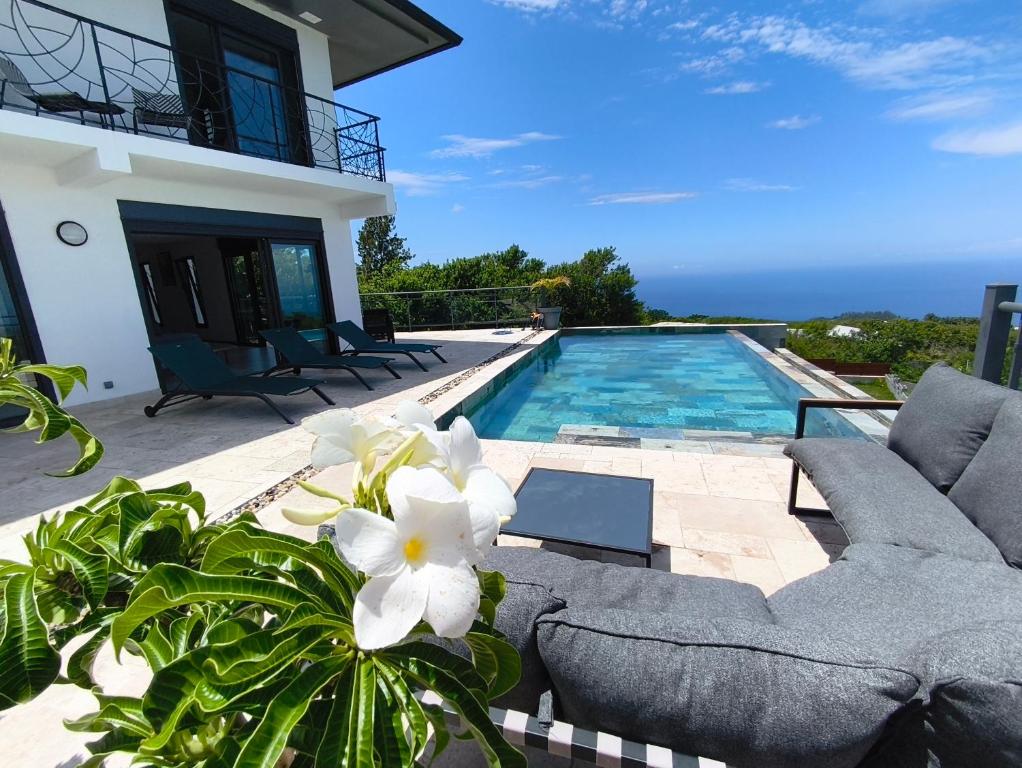 a villa with a swimming pool and a house at Mahot in Petite Île
