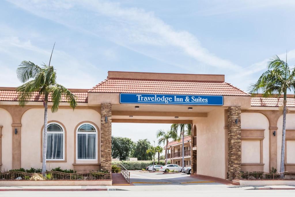 a building with a sign that reads traveler inn and suites at Travelodge Inn & Suites by Wyndham Bell Los Angeles Area in Bell