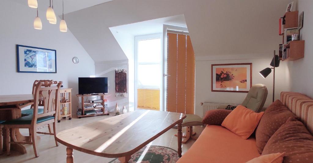 a living room with a couch and a table at Apartment Pawelzig in Kirchdorf