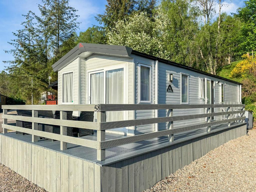 a tiny house sitting on a fence at Lodge 58 in Aviemore