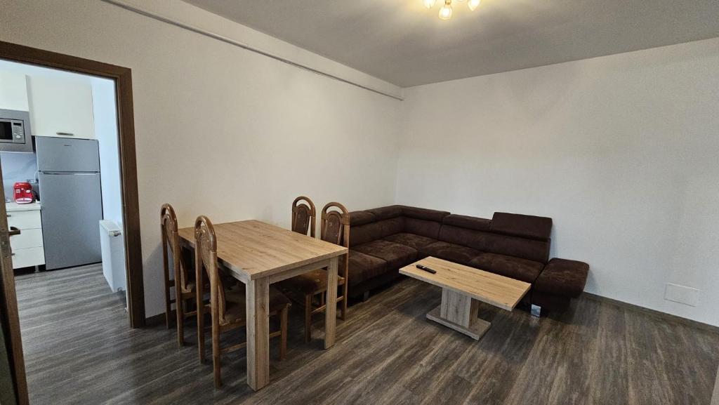 a living room with a couch and a table at Rădăuți Residence in Rădăuţi