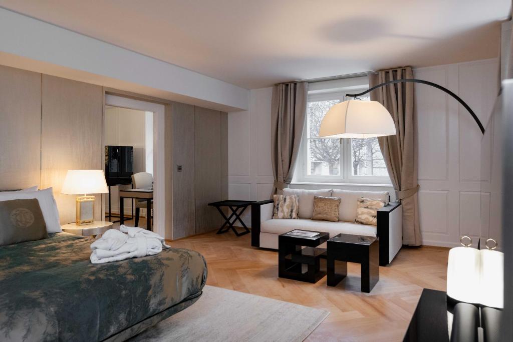 a bedroom with a bed and a living room at MEWS House Zürich in Zurich