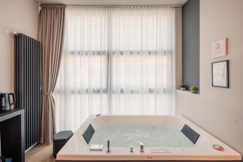 a bathroom with a bath tub in front of a window at Boutique Casa Giulietta Luxury in Como