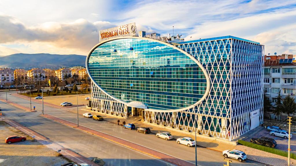 a large office building with a large glass facade at GHERDAN GOLD OTEL in Konya