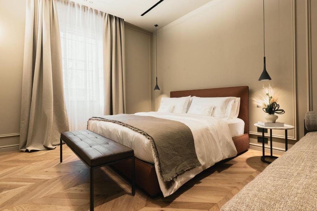a bedroom with a large bed and a window at Lenel Boutique Room - La Foresteria in Brescia