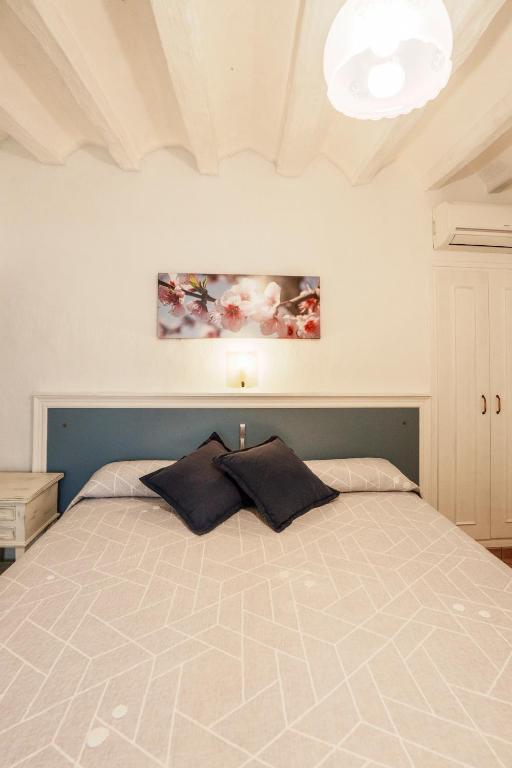 a bedroom with a bed with two pillows on it at Allotjaments Plaça Major-Aulina in Santa Pau