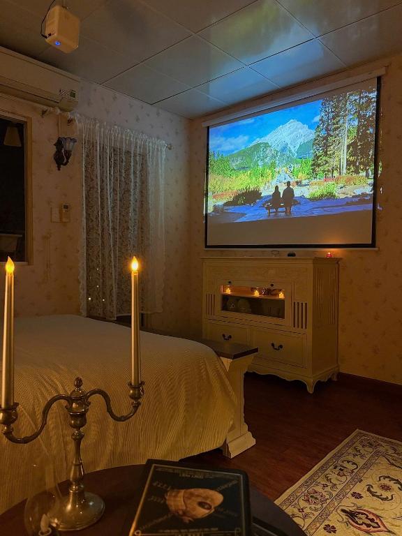 a bedroom with a bed and a flat screen tv at 221B Baker in Ấp Phú Thọ