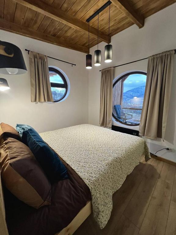 a bedroom with a bed and a large window at Secret place in Svalyava