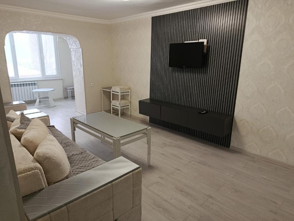 a living room with a couch and a tv at Jermuk Calm House in Jermuk
