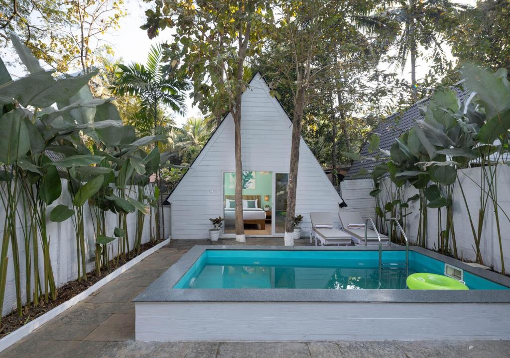 a swimming pool in the backyard of a house at Jalvasa Villa's in Canacona
