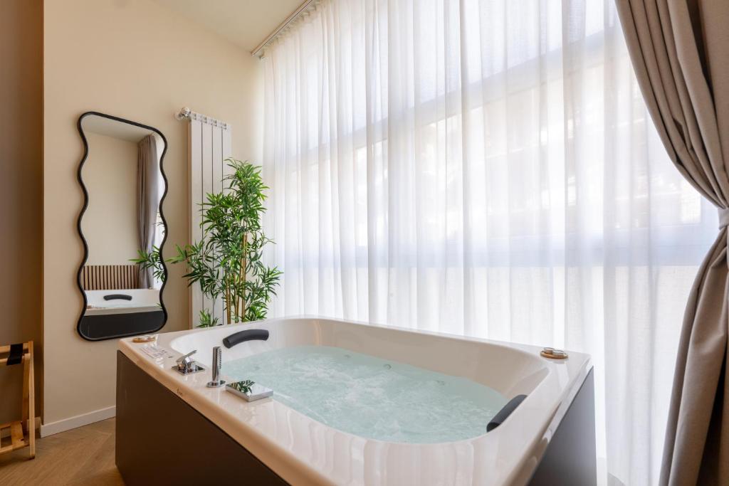 a bath tub in a bathroom with a window at Boutique Casa Giulietta in Como