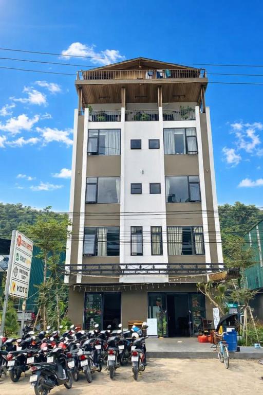 a group of motorcycles parked in front of a building at Cozy Hostel and Tours in Ha Giang