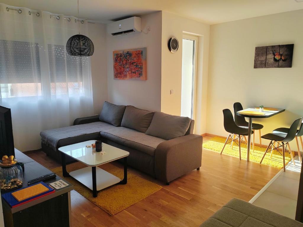 a living room with a couch and a table at For You in Vrnjci