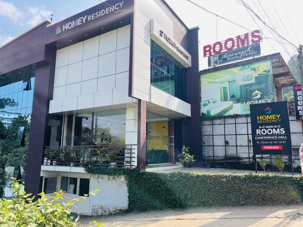 a store front of a building with a lot of windows at Homey - vythiri bus station in Vythiri