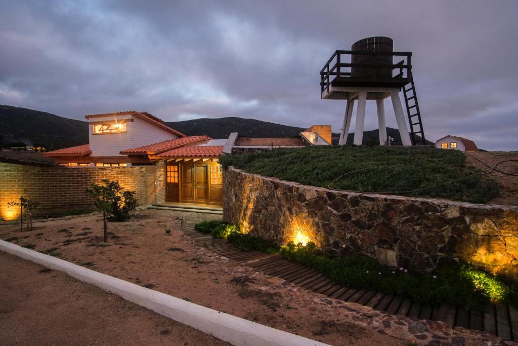 a house with a windmill on top of it at Rancho El Rossinyol in Valle de Guadalupe