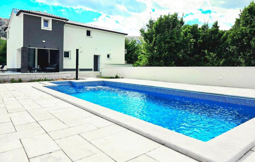 a swimming pool in front of a house at Villa Lux with swimming pool in Baška