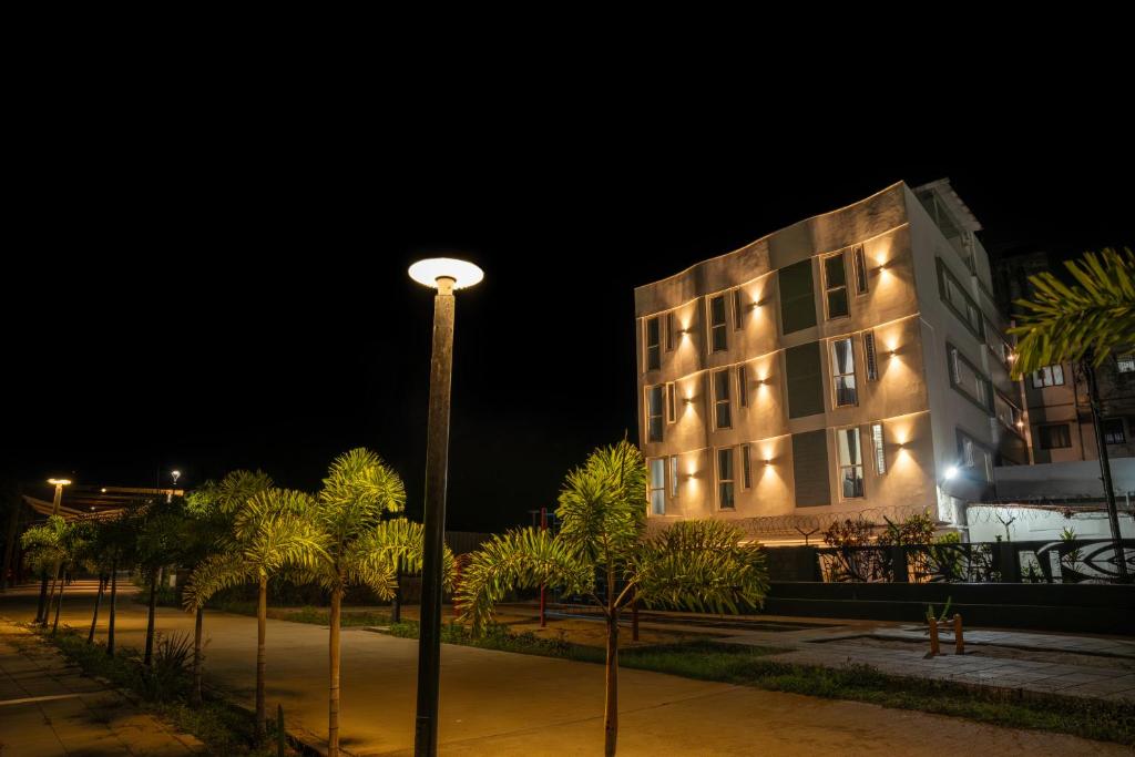 a street light in front of a building at night at Aafiya lakeview Apartments in Coimbatore