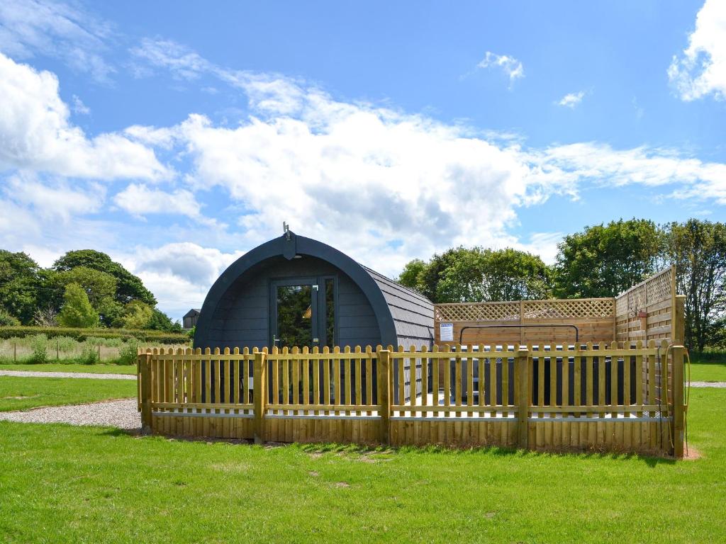 a wooden fence in front of a dome house at Sycamore - Uk47621 in Hunmanby