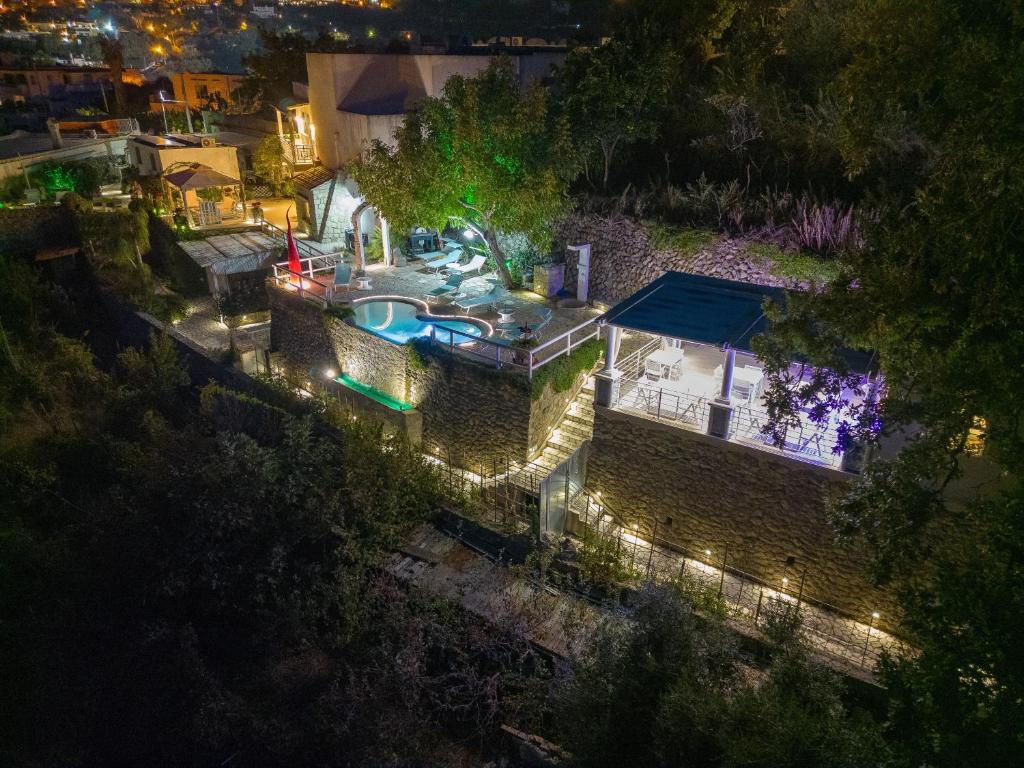 an aerial view of a house with a swimming pool at night at Belgodere di Mezzavia Apartments in Lacco Ameno