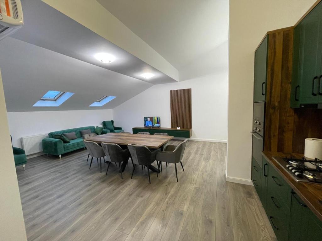 a kitchen and dining room with a table and chairs at Rădăuți Residence 3 in Rădăuţi