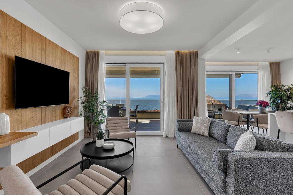 a living room with a couch and a tv at Apartment Adriatic Pearl -Makarska Exklusiv in Tučepi